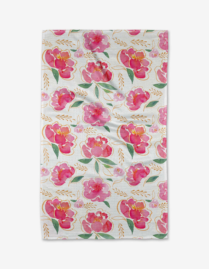 The Pink Peony Tea Towel by Elena Fay features a full-surface pattern of pink and red watercolor flowers, green leaves, and gold branches on white Geoweave fabric for a bright, cheerful look.