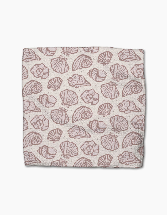 Pink Summer by Teri the Butter is a rectangular cloth made from recycled materials, featuring a repeating pattern of various pink seashell illustrations on a light beige background.
