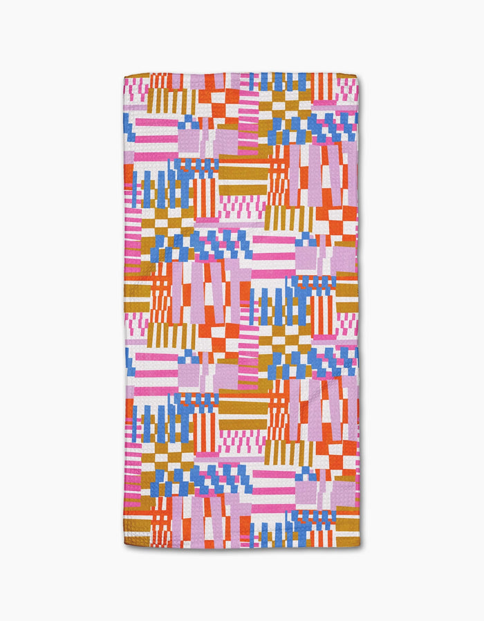 The Playful Stripes rug by Claire Iglesias features an abstract geometric pattern in pink, orange, blue, red, and white on a plain background. Made from recycled materials, it showcases stripes, checks, and blocks.