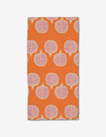 The Pomegranate Parade bar towel by Lizzie Clark features a vibrant orange Geoweave fabric with a repeating motif of halved pomegranates in pink and white.