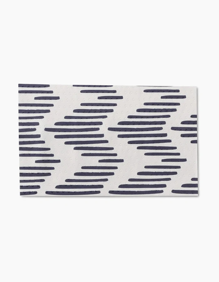 Pop Of Color by GEOMETRY is a rectangular white mat with diagonal navy blue zigzag lines, made from post-consumer recycled materials for an eco-friendly touch.