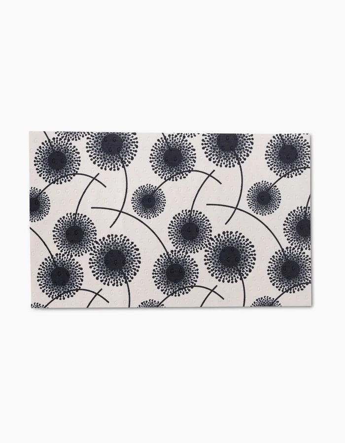 Pop Of Color by GEOMETRY is a rectangular tile with a white background and black stylized dandelion seed head patterns, inspired by eco-friendly Not Paper Towels made from post-consumer recycled materials.