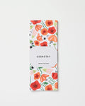 A folded, absorbent dish towel with a red, orange, and green floral pattern is shown. A white label around the towel reads Elisabeth Wing Poppy Power. The background is plain white.