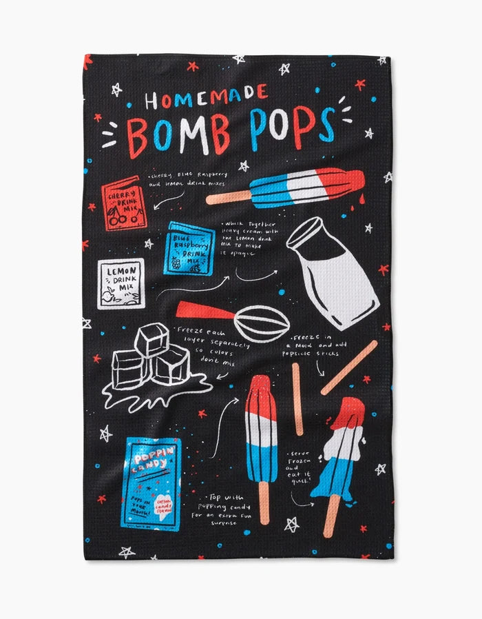 The Popsicles Tea Towel by Janna Sue Design features a colorful recipe with popsicles, milk, and ice cubes on a black background with red, white, and blue accents. Made of durable Geoweave fabric for lasting use.