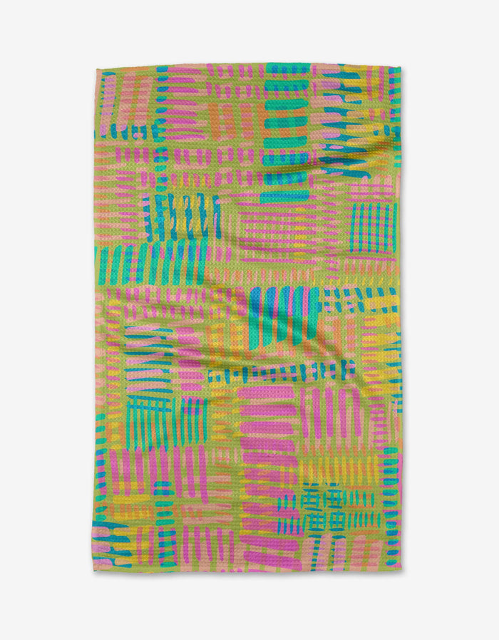 The Positive Vibes towel by Sareka Unique features a vibrant, abstract geometric pattern with pink, teal, yellow, and green rectangles and stripes on white Geoweave fabric—crafted from ultra-absorbent recycled materials.