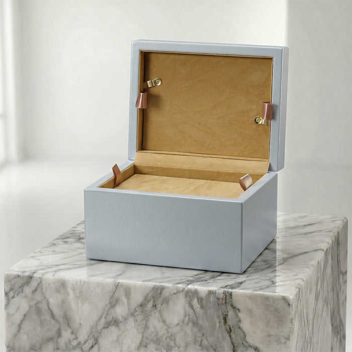 Opened blue pet urn on a marble surface