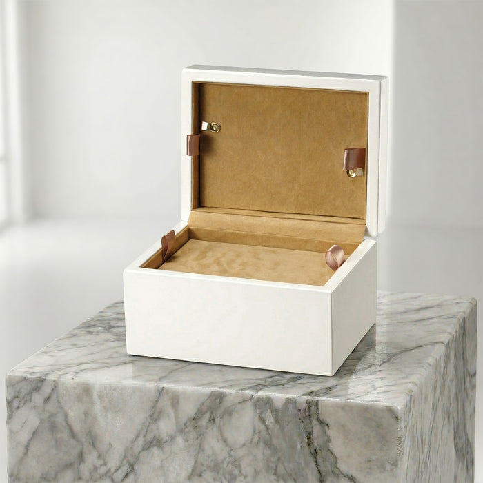 White Urn chest with brown interior on a marble surface