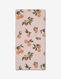 The Pretty In Peach bar towel by Janna Sue Design is a light pink, rectangular towel with a print of orange branches, green leaves, and clusters of oranges. Made from durable Geoweave fabric for excellent absorbency.