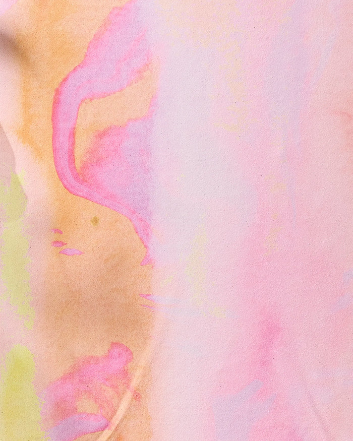 The Purity yoga towel by Geometry features an abstract watercolor design with soft pastels—pink, peach, yellow, and purple—blending in fluid patterns for a gentle, dreamy look and a non-slip, artistic feel.
