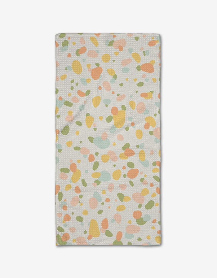 The Rainbow Freckles Bar Towel by Sweet Simple Vegan features a white background with abstract pastel spots in orange, green, yellow, and pink, and is crafted from absorbent Geoweave fabric.