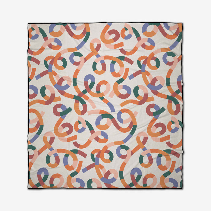 The Rainbow Squiggles beach blanket by Claire Iglesias is quick-drying and features a playful, abstract ribbon design in orange, green, purple, and coral on cream—perfect for vibrant days by the water.