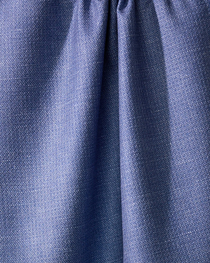 Close-up of Geometrys Rainfield, a blue absorbent kitchen towel crafted from recycled materials, with a subtle textured pattern and gathered seam near the top for soft folds and shadows.