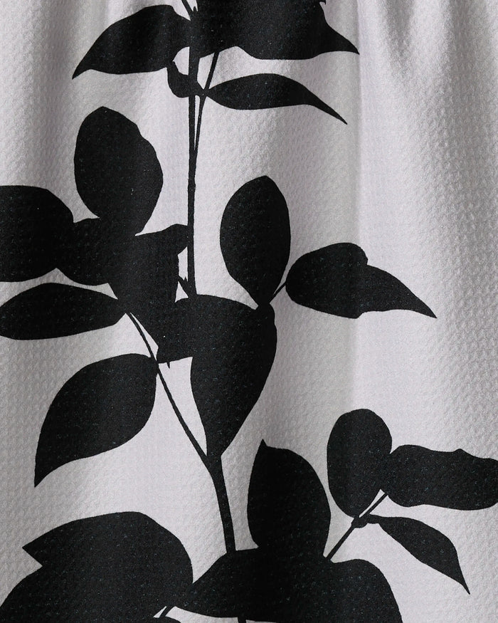 The Raspberry by PrintedPlant features a black silhouette of leafy stems with rounded leaves on textured white, ideal for a stylish recycled kitchen towel.