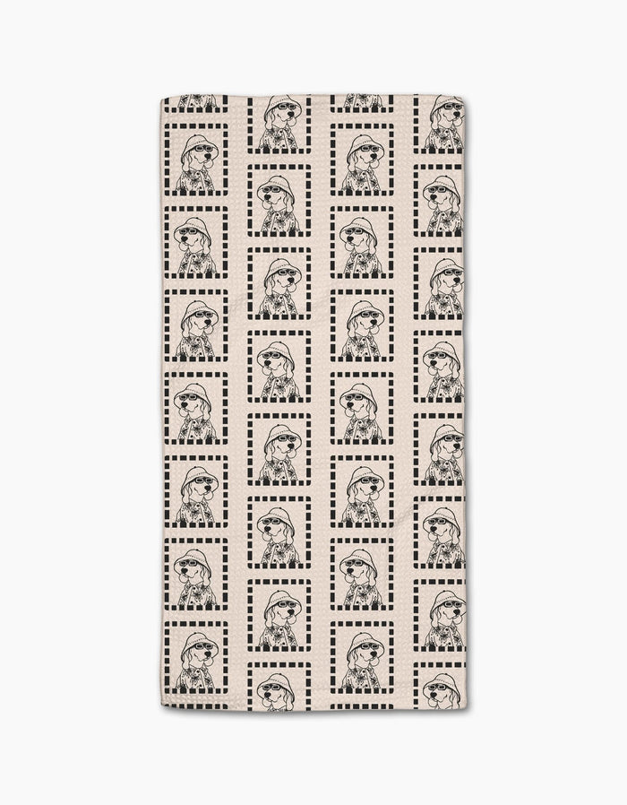 The Geometry Ready For Summer Doggy Bar Towel is rectangular, beige, and features a soft Geoweave fabric with a black line art pattern of a girl in a beret and striped shirt inside checkered squares.