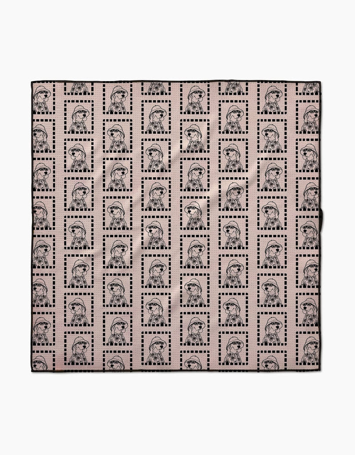 The Geometry Ready For Summer Doggy is an eco-friendly, absorbent fabric square with repeated womens faces in dotted rectangles on a light pink background—perfect as stylish dog towels.