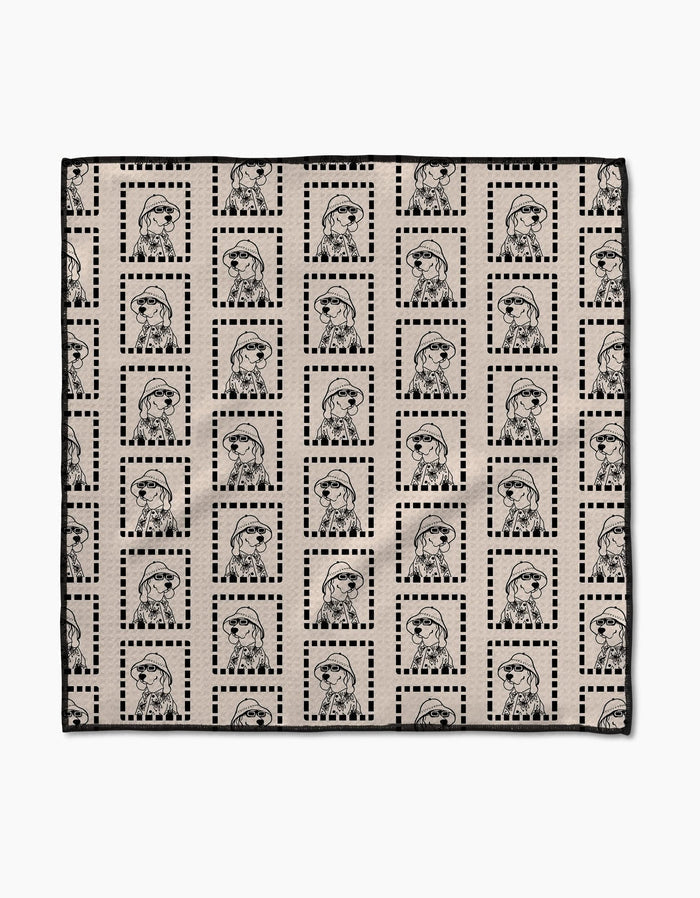 The Ready For Summer Doggy Paw Towel by Geometry features beige Geoweave fabric with a grid of dotted black squares and outlined figures in berets and jackets, combining stylish design with ultra-absorbent performance.