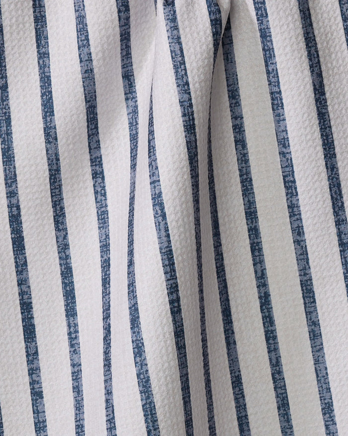 Close-up of the Becki Owens Ren Blue tea towel, featuring vertical blue and white stripes on textured, gently wrinkled fabric—showcasing the unique character of recycled materials.