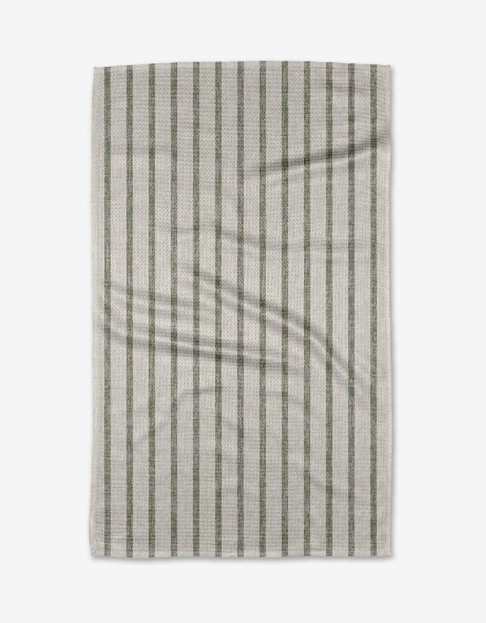 The Becki Owens Ren Sage tea towel, made from Geoweave™ fabric and recycled materials, features evenly spaced vertical green stripes on beige and is shown flat on a white background with light creasing.