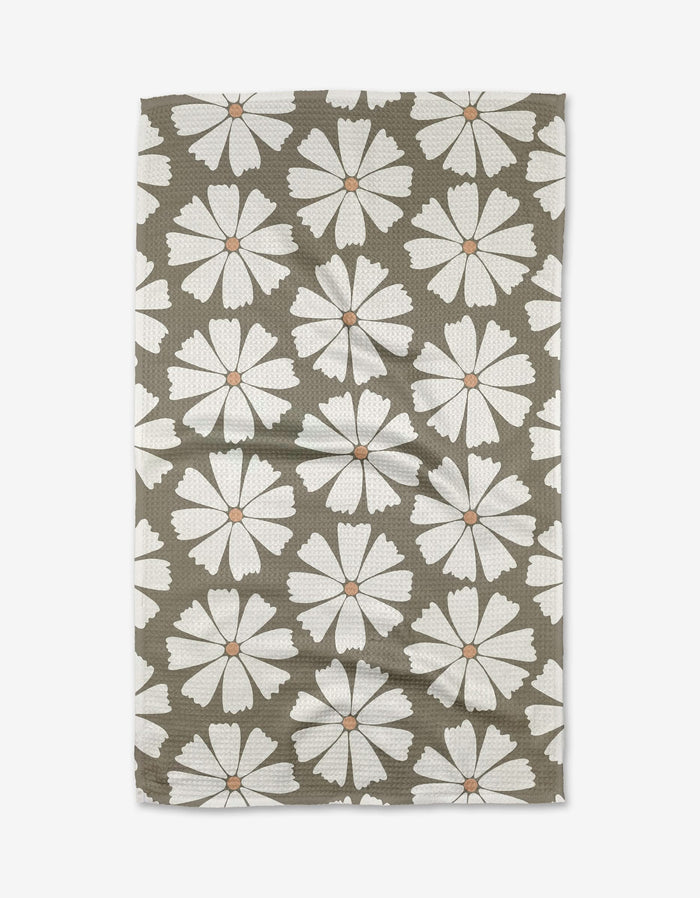 Retro Daisy by Hufton Studio is a rectangular tea towel crafted from recycled materials, featuring large white daisies with orange centers on an olive green background and a subtly textured, wrinkled finish.