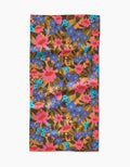 The Retro Garden bar towel by Lisa Nelson features a vibrant floral pattern on a brown background and is crafted from soft Geoweave fabric for enhanced absorbency.