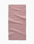 The Teri the Butter Retro Geo bar towel, made from Geoweave fabric, features a red and white repeating geometric pattern and is shown laid flat with slight wrinkles against a white background.