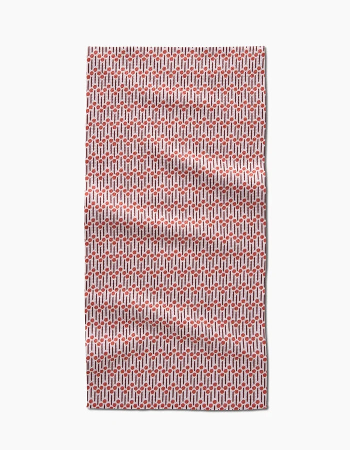 The Teri the Butter Retro Geo bar towel, made from Geoweave fabric, features a red and white repeating geometric pattern and is shown laid flat with slight wrinkles against a white background.