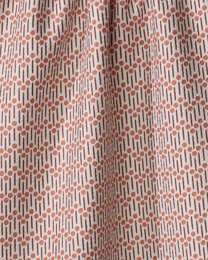 A close-up of Teri the Butter's Retro Geo tea towel, made from quick-drying fabric, showcases a cream background with rust-colored dots and vertical lines in a subtle geometric repeat pattern.