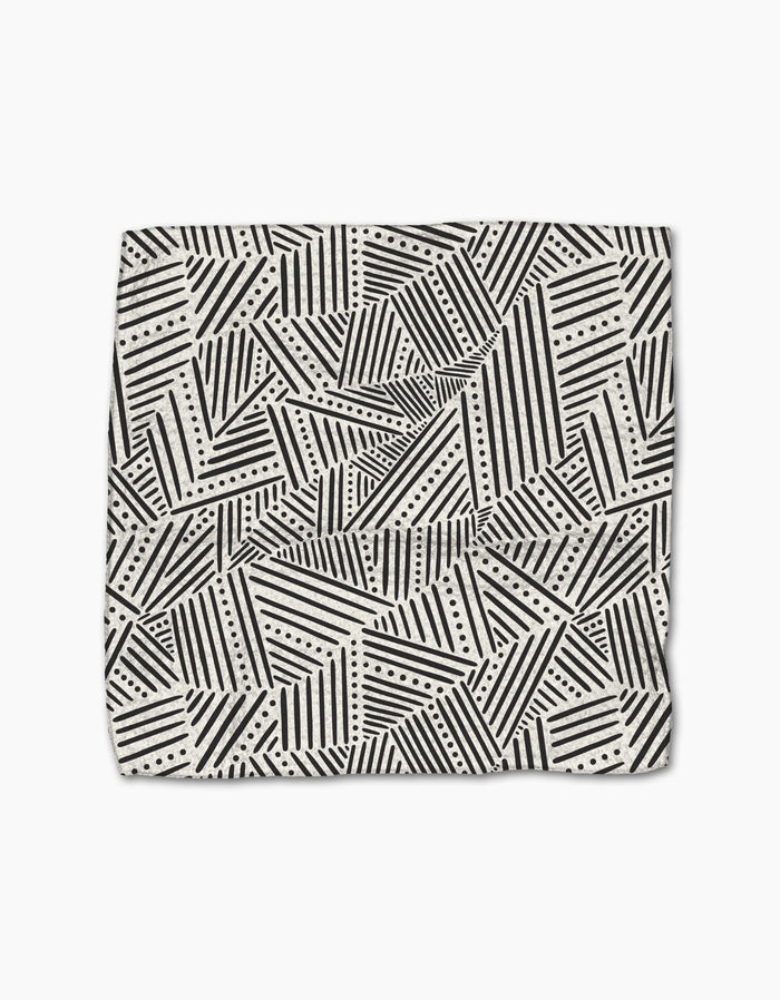 The Rhythm Current Stripes dishtowel by Sarah Daugherty features a folded, super-absorbent design with black and white geometric diagonal stripes, triangles, and dotted lines on a light background.