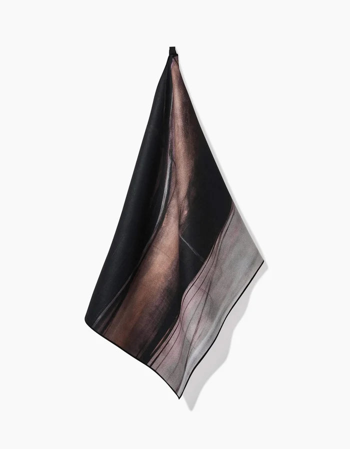 The Jennifer Janesko Rhythm square silk scarf is displayed against a white background, showcasing an abstract design in black, brown, and muted grayish-pink tones.