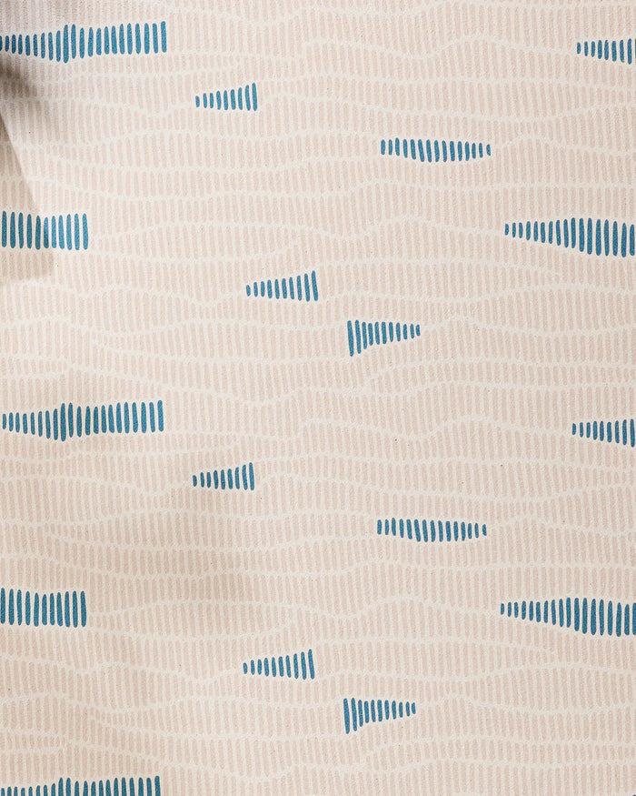 Ridgeline by Twig + Spark features beige fabric with wavy tan lines and spaced blue accents, creating a modern geometric style—perfect for a non-slip yoga towel that blends style and function.