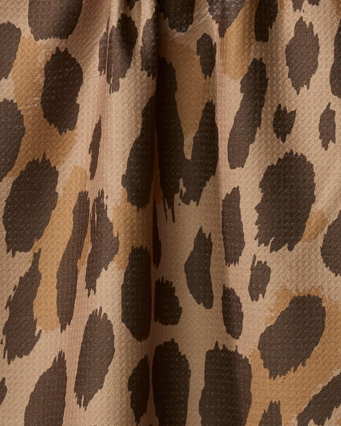 Close-up of the Geometry Roam absorbent dish towel, featuring a leopard print with irregular dark brown and black spots on a light tan, textured fabric—perfect for adding flair to your kitchen essentials.
