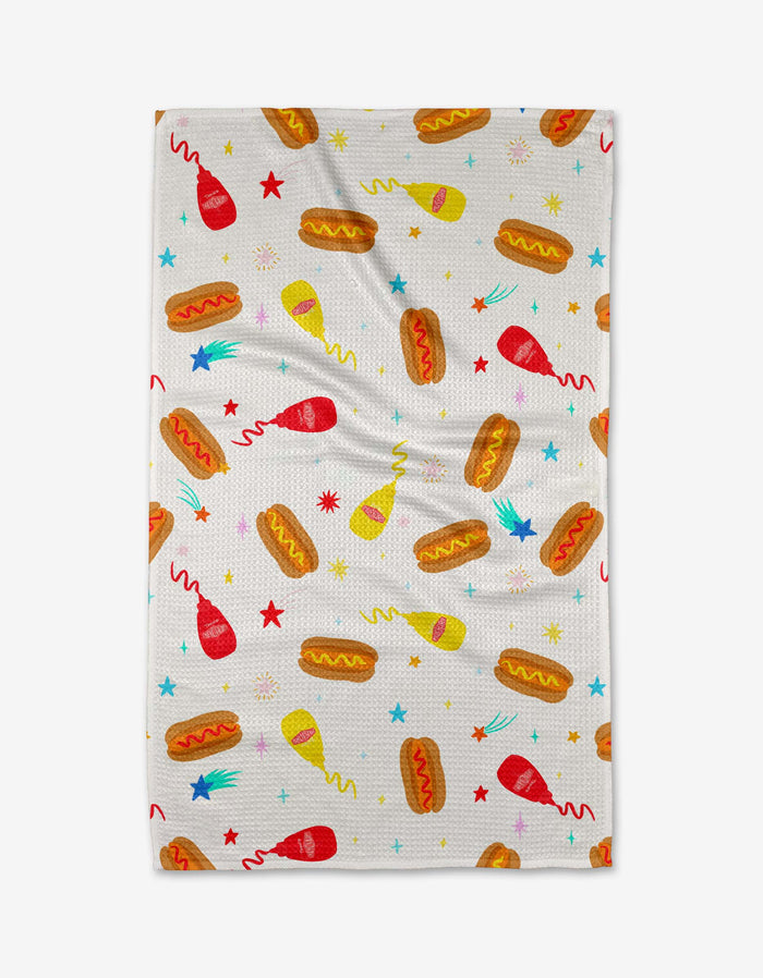 The Rocket Relish tea towel by Vaishali Design Studio features playful hot dogs, ketchup and mustard bottles, plus colorful stars on a white background—perfect for adding fun to your kitchen.