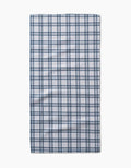 The Roma bar towel by Kelsi Fullmer is a rectangular, white Geoweave fabric towel with a dark blue plaid pattern of evenly spaced lines, shown laid flat on a plain white background.