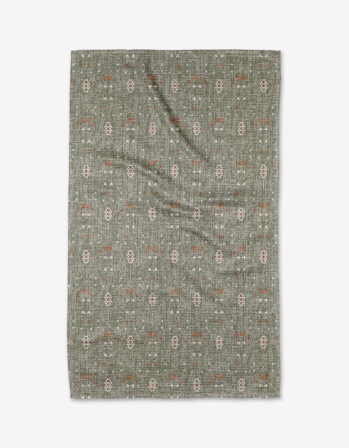 The Rulon Sage rug by Becki Owens is a rectangular green mat made from ultra-absorbent Geoweave fabric, featuring subtle cream and rust geometric and floral patterns, displayed flat on a white background.