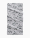 The Sage Pumpkin Field bar towel by Charlie Rowan Designs features hand-drawn pumpkins and dark gray dots evenly spaced across Geoweave fabric, creating a charming pattern on a slightly textured surface.
