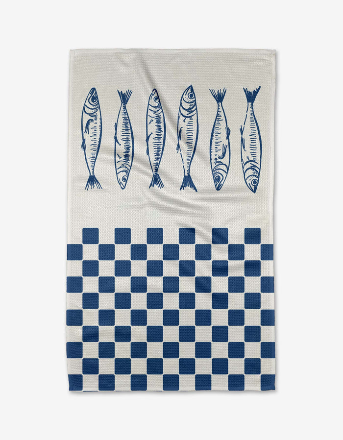 The Hufton Studio Sardine Check Blue tea towel features five blue fish along the top and a blue-and-white checkered pattern on the bottom half, printed on white Geoweave fabric.