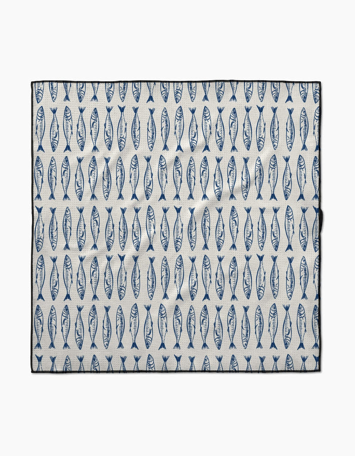 The Sardine Stripes mat by Hufton Studio is a rectangular white mat made from recycled materials, featuring rows of evenly spaced vertical blue fish and a black border.