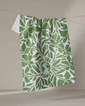 The Save the Planet tea towel by Sweet Simple Vegan features green leaf patterns and an Earth illustration with "SAVE THE PLANET" text, all on white. Made from recycled materials, this quick-drying cloth offers eco-friendly style and practical use.