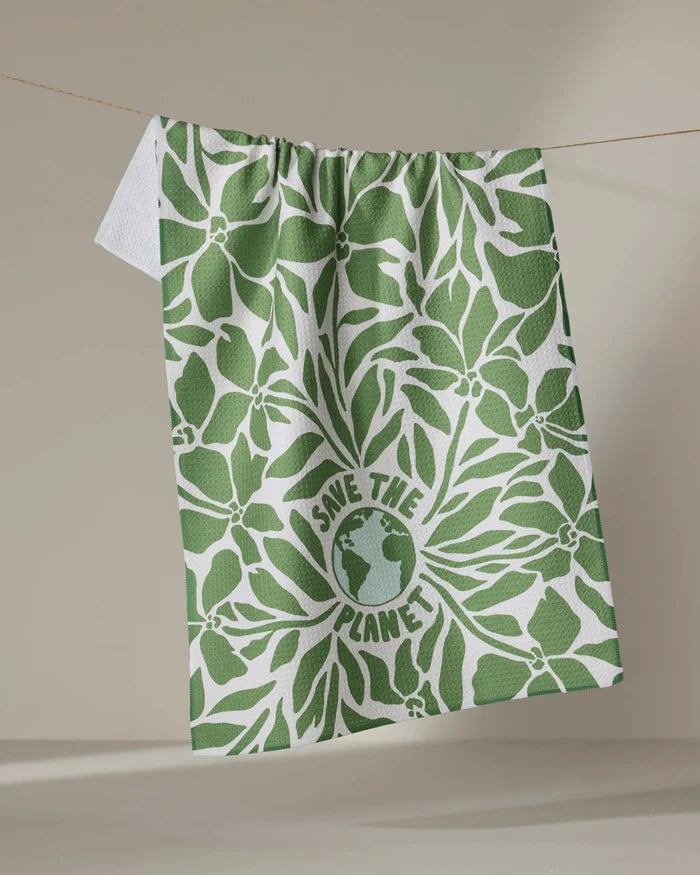 The Save the Planet tea towel by Sweet Simple Vegan features green leaf patterns and an Earth illustration with "SAVE THE PLANET" text, all on white. Made from recycled materials, this quick-drying cloth offers eco-friendly style and practical use.