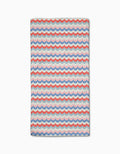 The Geometry Scallop Stripes Bar Towel features a blue, red, and white scalloped wave pattern on cream. Made from durable Geoweave fabric for superior absorbency and quick drying, shown flat on a white surface.