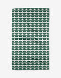 The Buy Guides Scallops - Evergreen Tea Towel displays dark green and white semi-circles on white, crafted from post-consumer recycled materials. Its eco-friendly, scalloped design is featured as it lies flat.