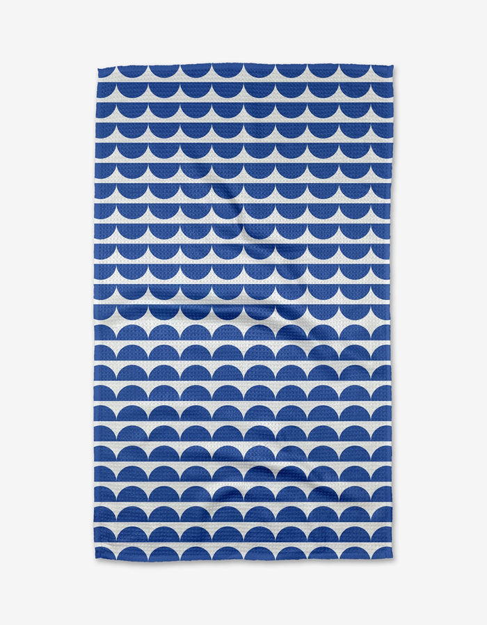 The Buy Guide’s Scallops - Navy towel features a repeating navy and white scallop pattern on white Geoweave fabric, offering an ultra-absorbent and stylish rectangular design.