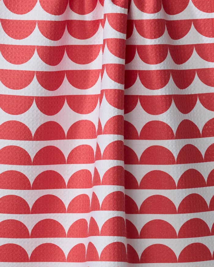 Close-up of The Buy Guide's Scallops - Red tea towel, made from recycled materials and featuring a repeating red semicircle pattern on white fabric with gentle folds for added texture.