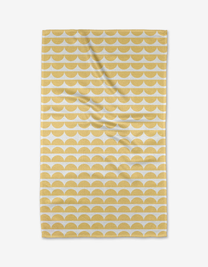 The Buy Guides Scallops - Yellow is a rectangular tea towel with yellow semi-circles in horizontal rows on white Geoweave™ fabric, shown flat with slight wrinkles.