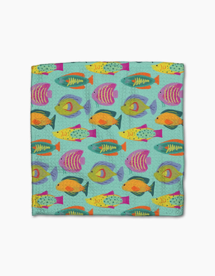 The Geometry Schooling dishcloth set features a super-absorbent design with a colorful, repeating pattern of stylized fish in yellow, orange, purple, pink, and green on a light blue background.