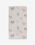 The Seahorse Serendipity Luxe Bath Towel by Janna Sue Design is a white, rectangular towel featuring colorful sea creatures, coral, and seaweed in blue, pink, orange, and green. Made with ultra-absorbent Geoweave technology. Shown flat on a white background.
