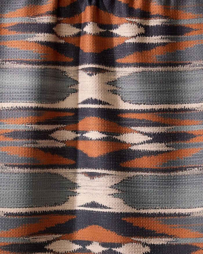 The Geometry Sedona tea towel features a geometric textile pattern with horizontal bands in orange, navy, white, and gray, showcasing symmetrical diamonds and zigzags—perfect for brightening your kitchen with its quick-drying design.