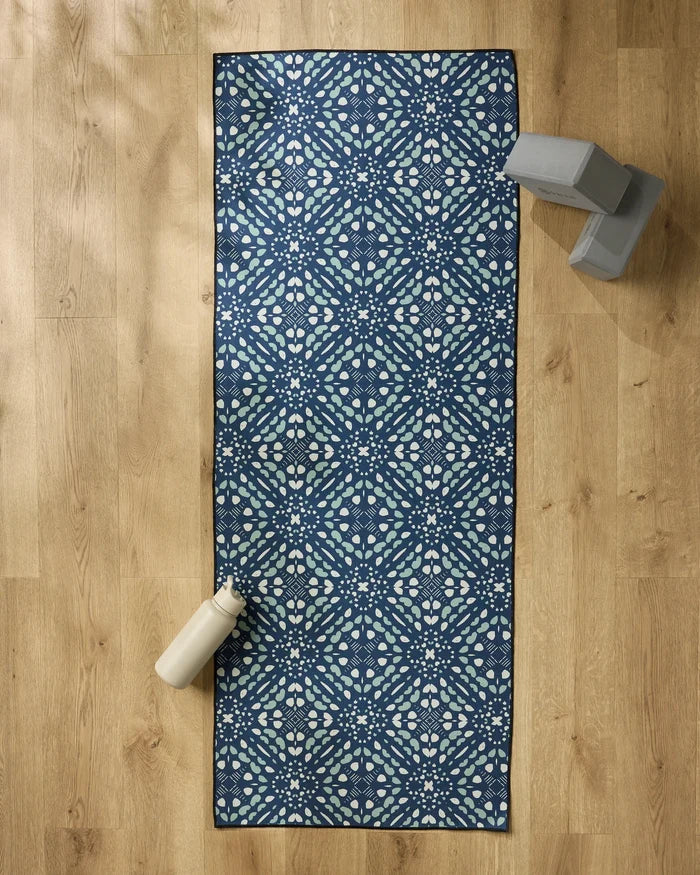 A package of Seeds and Nuts by Twig + Spark rests on a wooden floor, with a water bottle and yoga blocks stacked nearby.