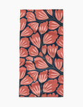 The Sheila bar towel by Amy MacCready is made from Geoweave fabric and showcases large coral flowers with white accents and dark stems on a deep navy blue background.