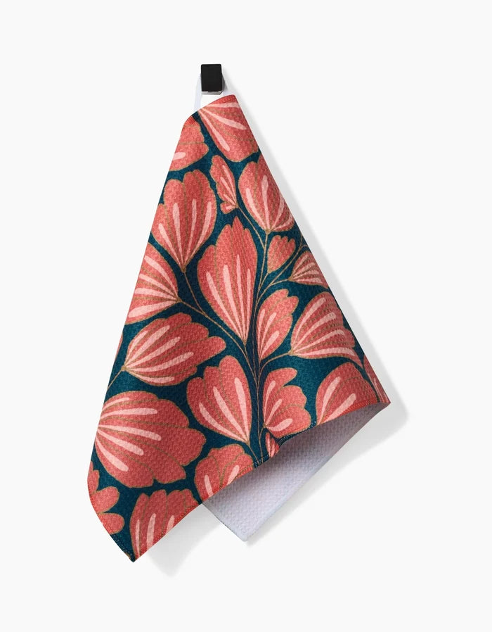 Presenting Sheila by Amy MacCready: a vibrant pink and coral floral bar towel on dark teal Geoweave fabric, featuring a black hanging loop. Shown here against a white background.